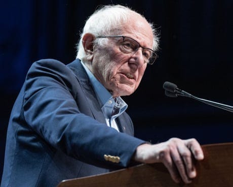 a man speaks into a microphone at a lectern