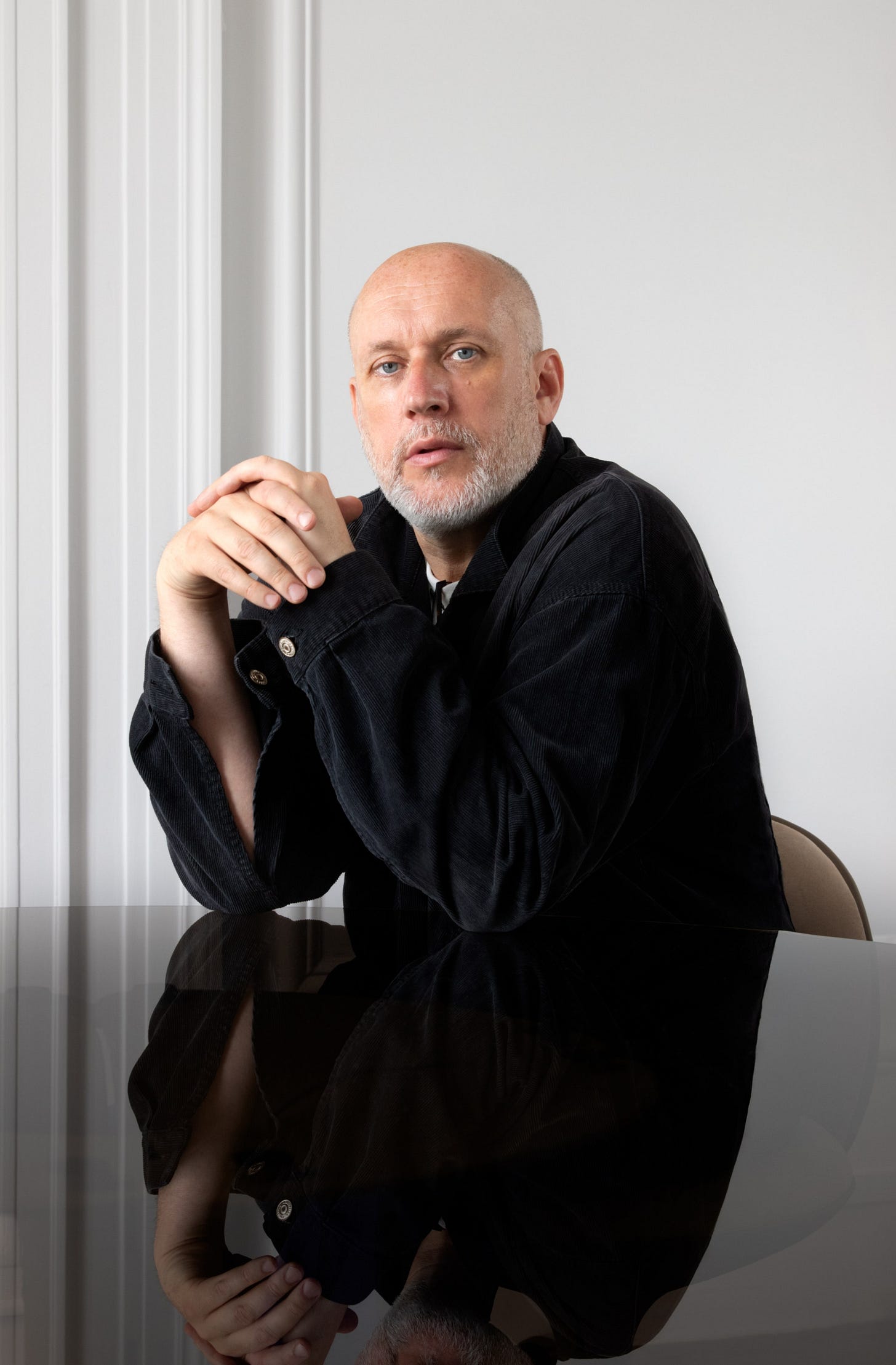 Image may contain Face Head Person Photography Portrait Sitting Body Part Finger Hand Adult and Sad