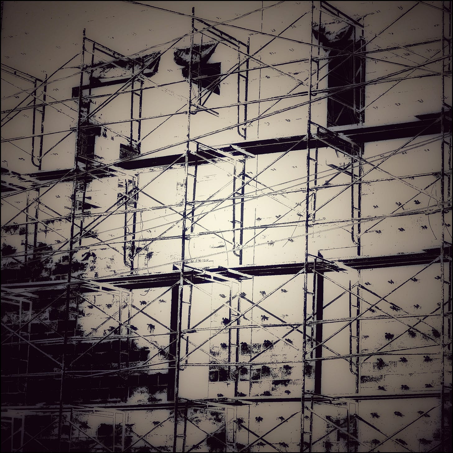 A blurry monotone photo of what seems to be a blank, windowless wall on the exterior of a building. The wall is studded with a grid of projections of unknown purpose, and surrounded by some kind of scaffoling which completely encases the building: wall to wall and ground to rooftop. No one is on the scaffolding; we have no idea what it might or might not be used for. Could it be electrified?