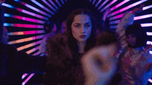 a blurry picture of a woman dancing in a nightclub