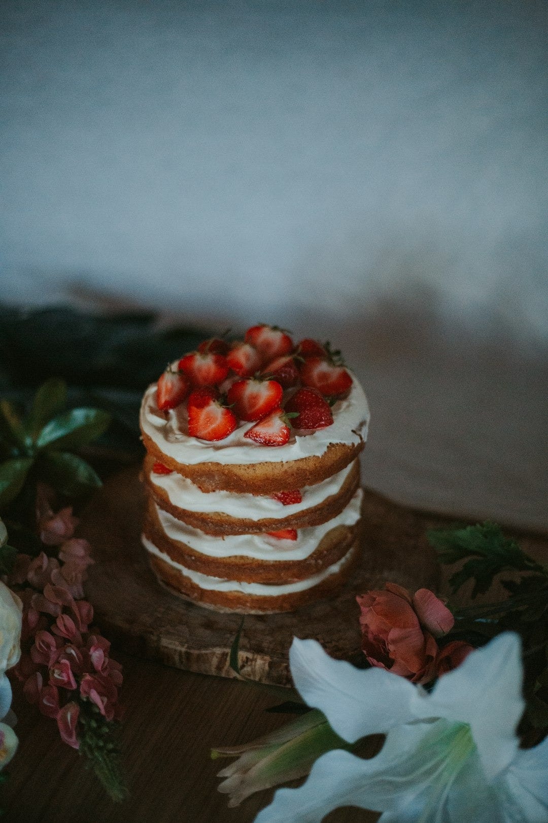 a close up of a cake on a table with flowers