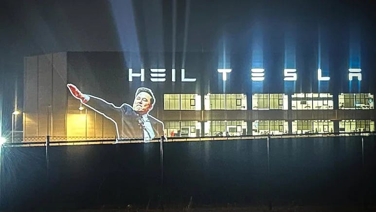 Elon Musk projected onto his german factory, the words "heil tesla" are projected too Elon Musk projected onto his german factory, the words "heil tesla" are projected too