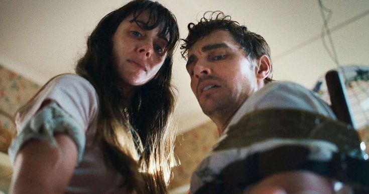 This may contain: a man and woman standing next to each other in front of a mirror looking at something