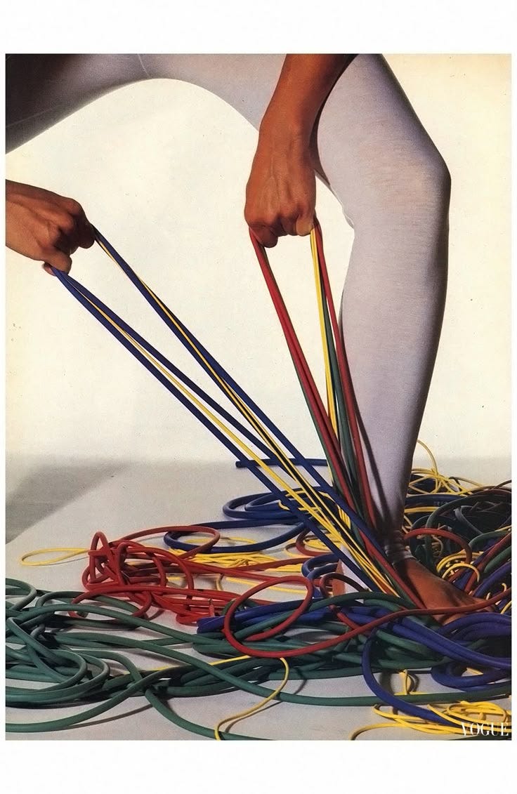 This may contain: an image of a person bending over with many wires on the floor in front of them