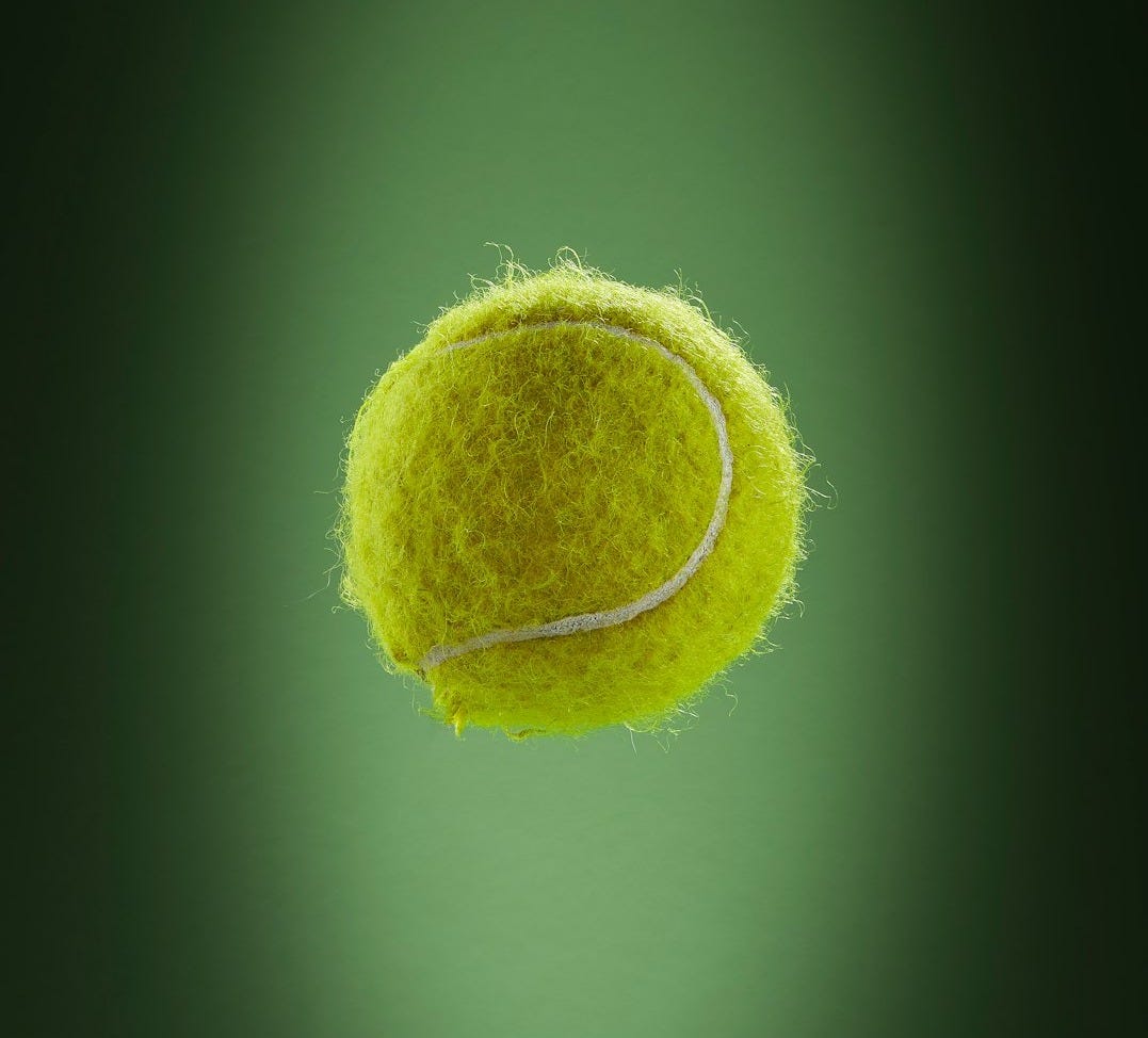 a tennis ball is flying through the air a tennis ball is flying through the air
