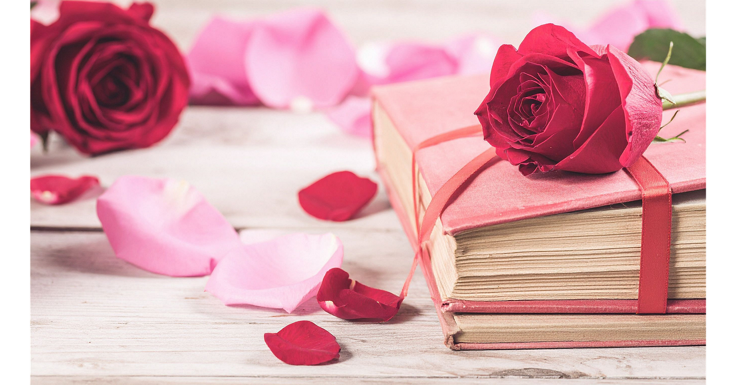 Stack of books decorated with red roses and scattered petals, creating a romantic reading display.