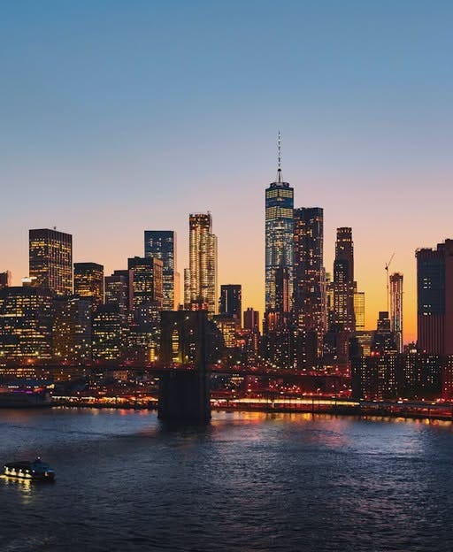May be an image of skyscraper, twilight, the Brooklyn Bridge and the Queensboro Bridge
