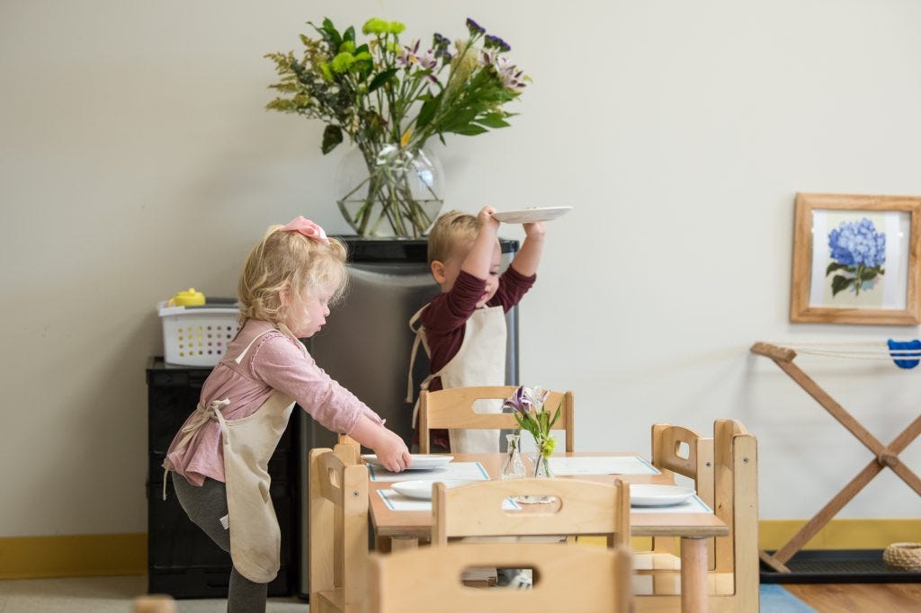 Children setting a dining table together as part of practical life work in the Guidepost Montessori experience Children setting a dining table together as part of practical life work in the Guidepost Montessori experience