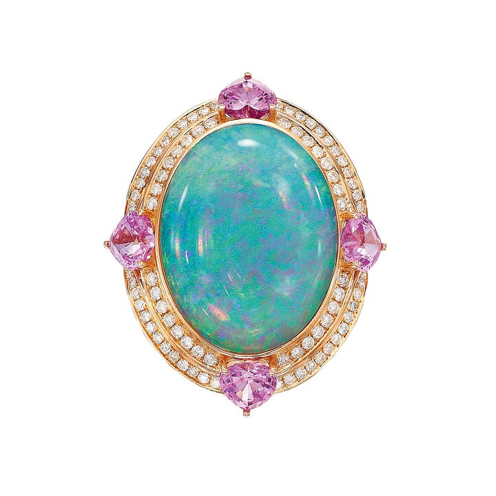 A student at the bench at MasterPeace Academy, an opal, diamond and sapphire brooch by Birmingham-based jeweller Fei Liu.