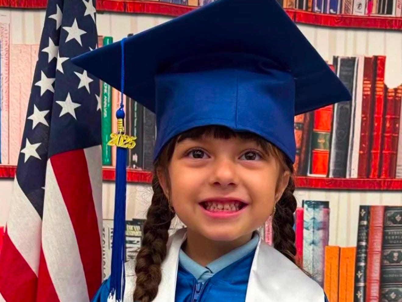 Martina in a graduation gown (she is a 6-year-old imprisoned by ICE) Martina in a graduation gown (she is a 6-year-old imprisoned by ICE)