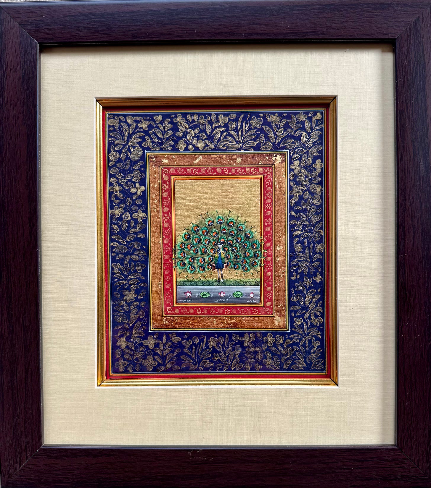 Framed miniature painting of a peacock with ornate border details.