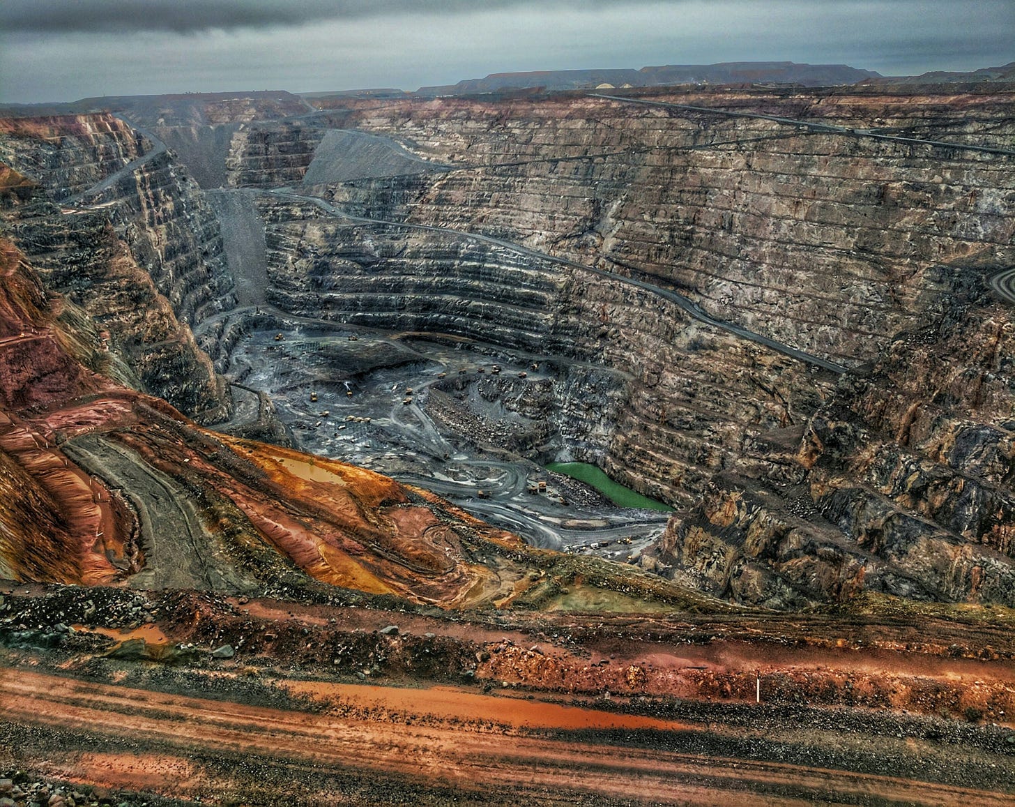 a view of a large open pit in the middle of nowhere