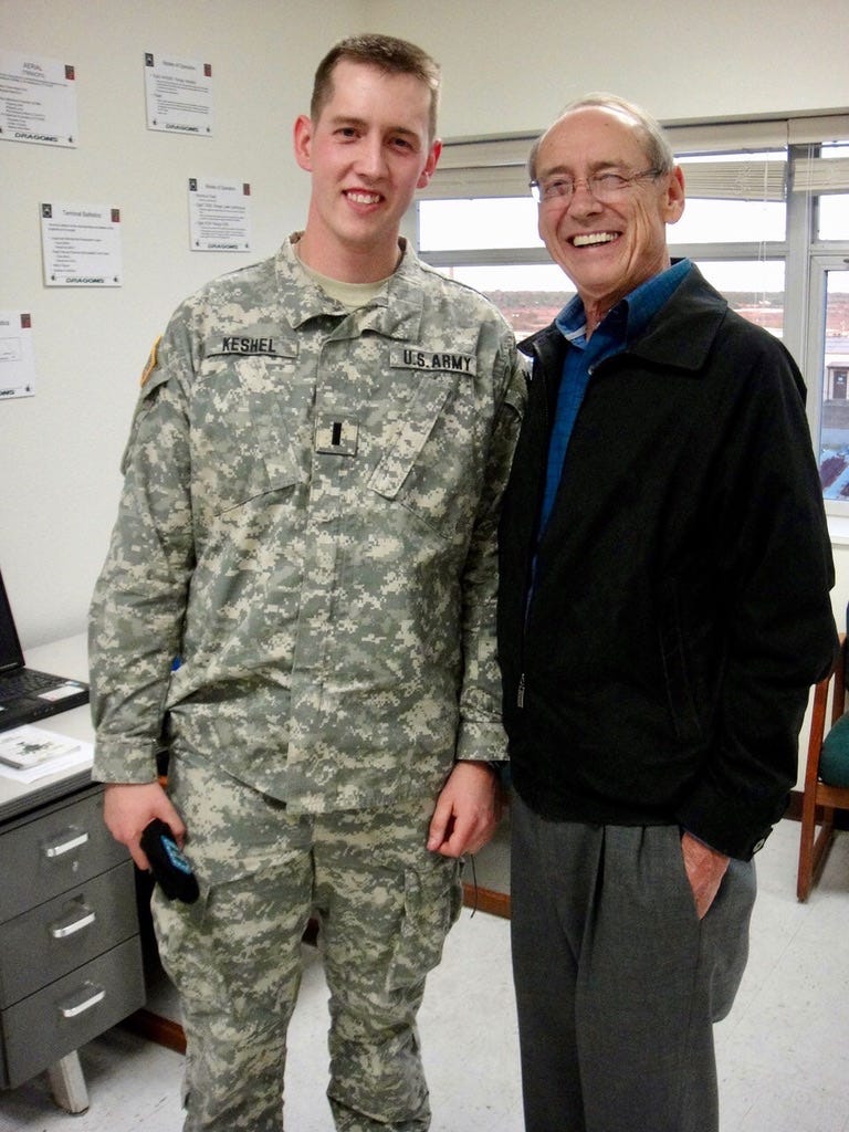A person standing next to a soldier

Description automatically generated
