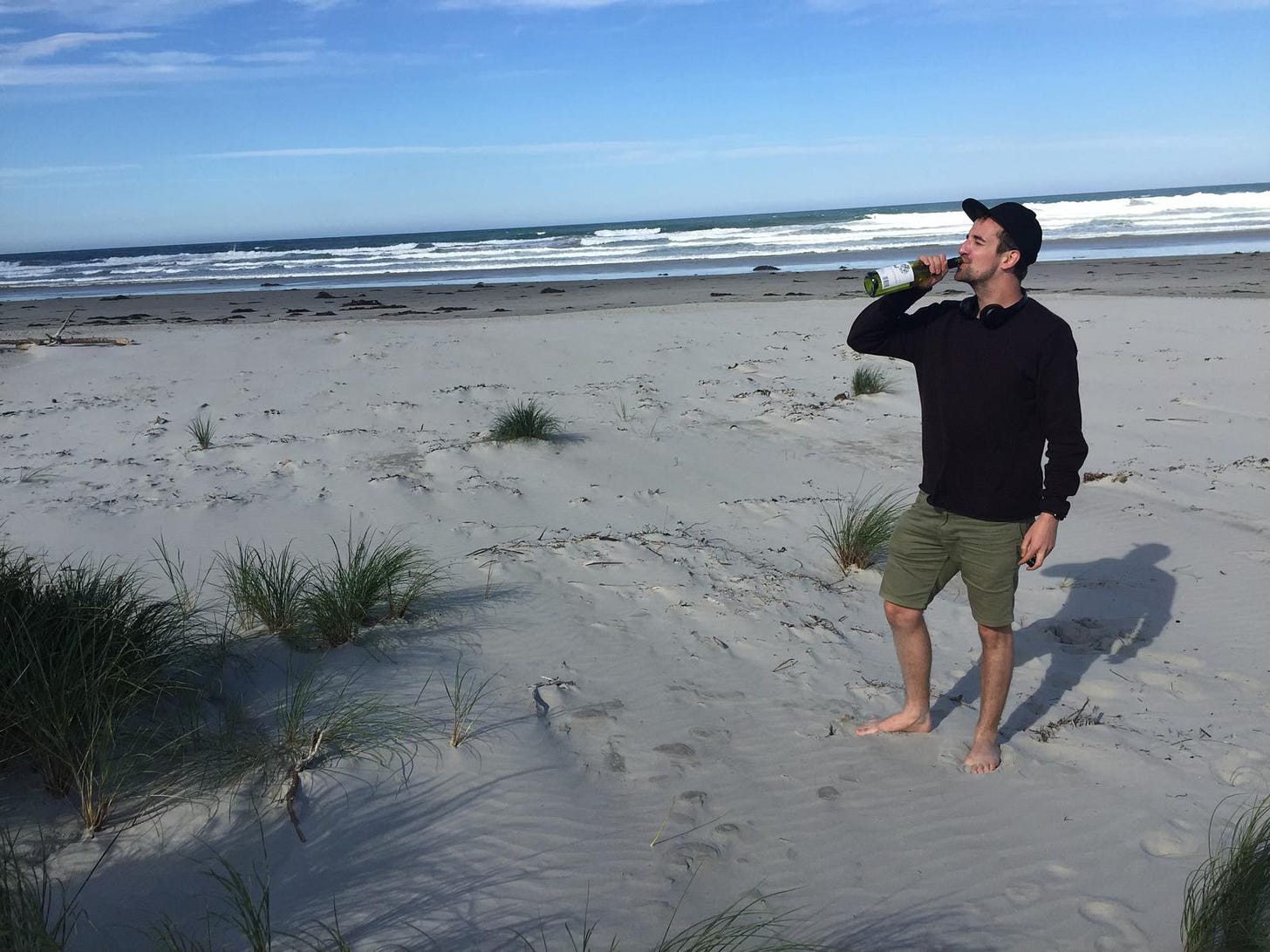 David drinking champagne from the bottle on a beach in New Zealand in his twenties David drinking champagne from the bottle on a beach in New Zealand in his twenties