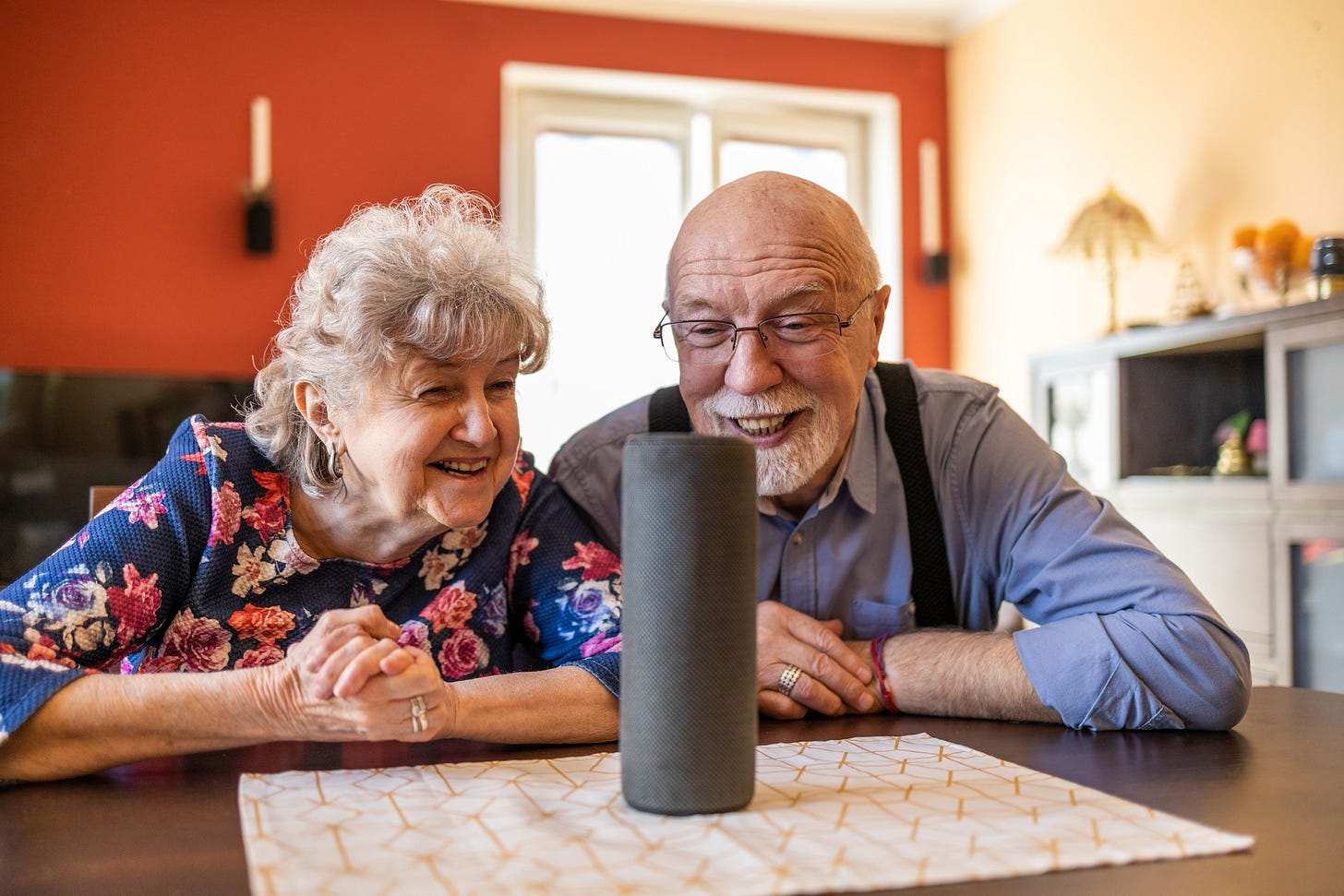 Excited senior couple using a Virtual Assistant at home Excited senior couple using a Virtual Assistant at home