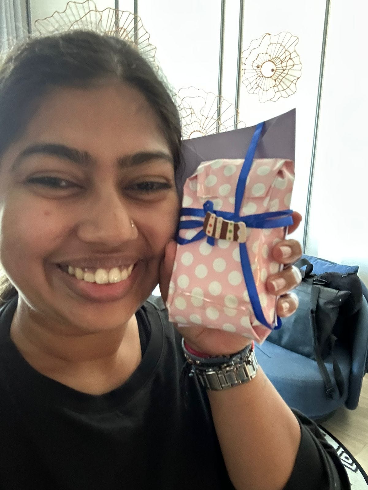 Seni holding a little present from her mother next to her