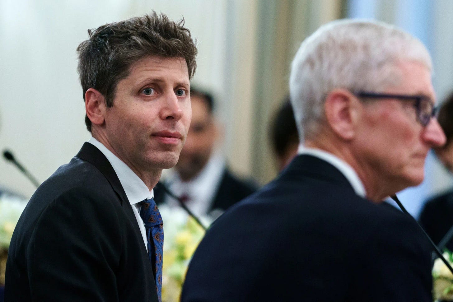 OpenAI’s Sam Altman and Apple CEO Tim Cook at a White House dinner in 2025.