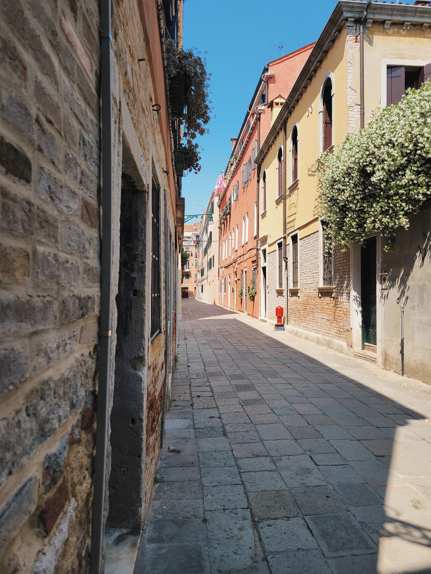 Sunlight reflecting along a quiet, narrow street in Venice Sunlight reflecting along a quiet, narrow street in Venice