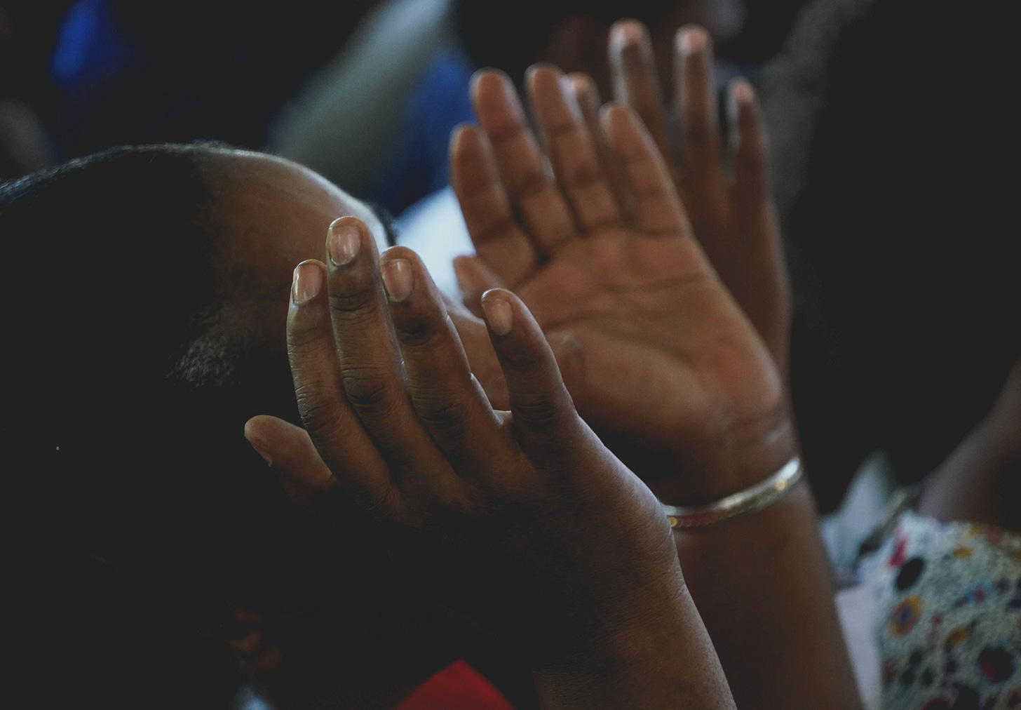 A woman lifting hands in prayer A woman lifting hands in prayer