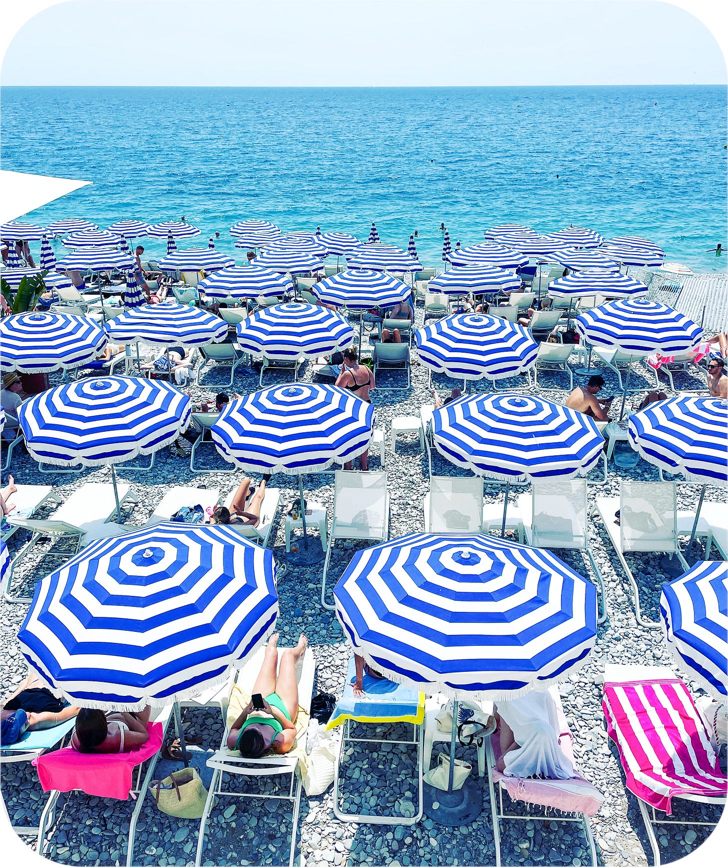 Striped umbrellas on the beach. Nice, France