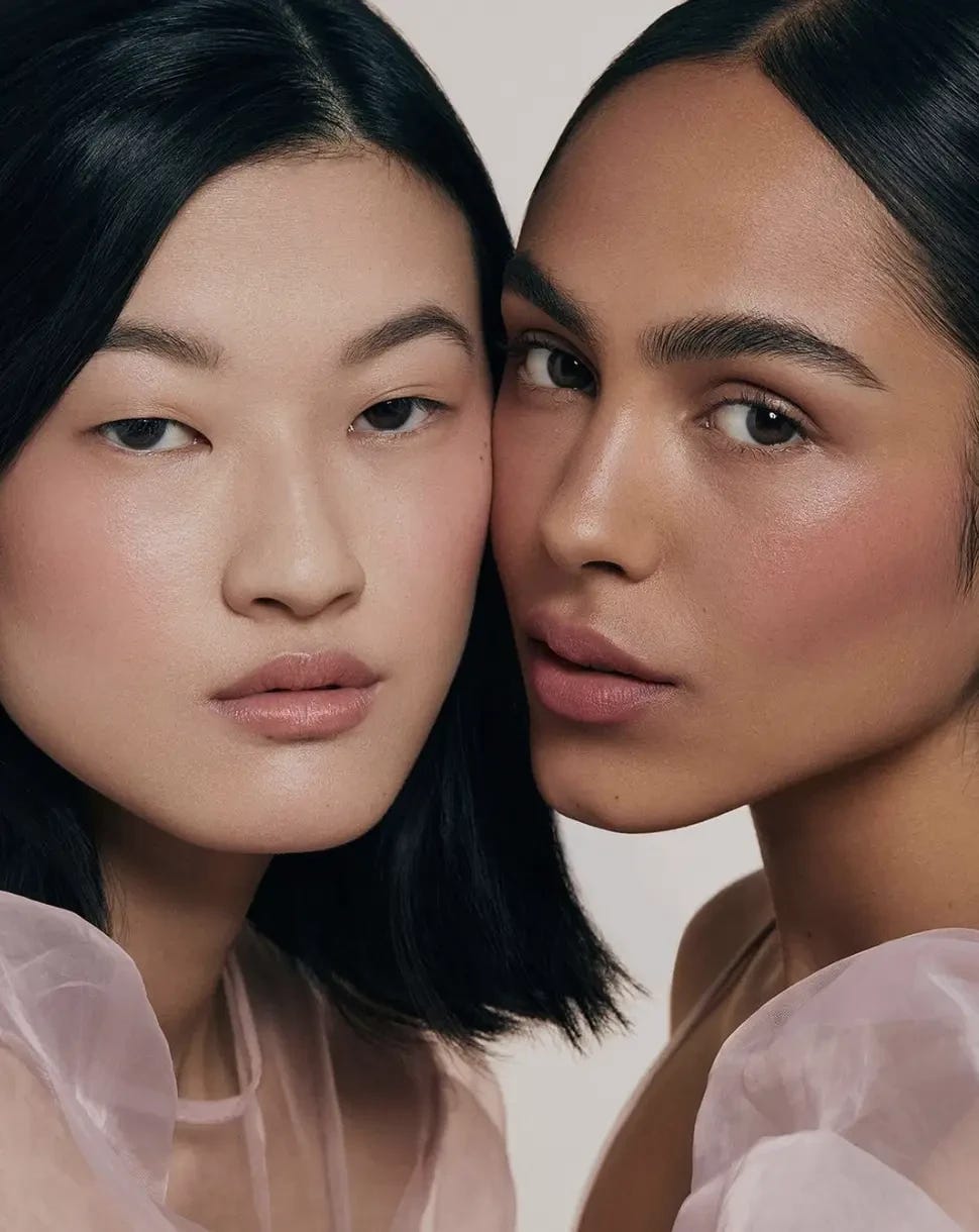 Two models depicting the skincare-insfused makeup trend with clean skin and gorgeous pink blush. 