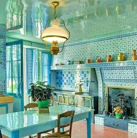 yellow dining room., blue kitchen, stairwell, two beds with canopy, living room and stairwell with tiles
