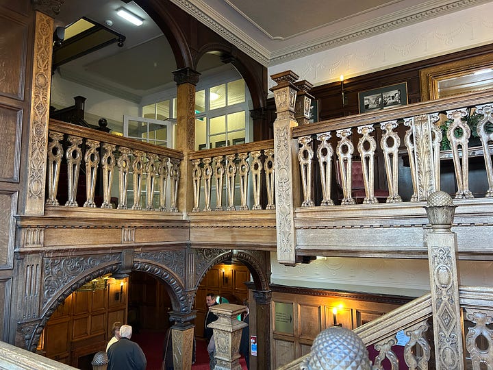Four images of the grand hand-carved oak staircase at Petwood Hotel, Woodhall Spa. 