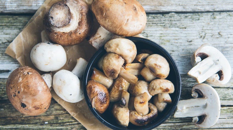 Button mushrooms on a board
