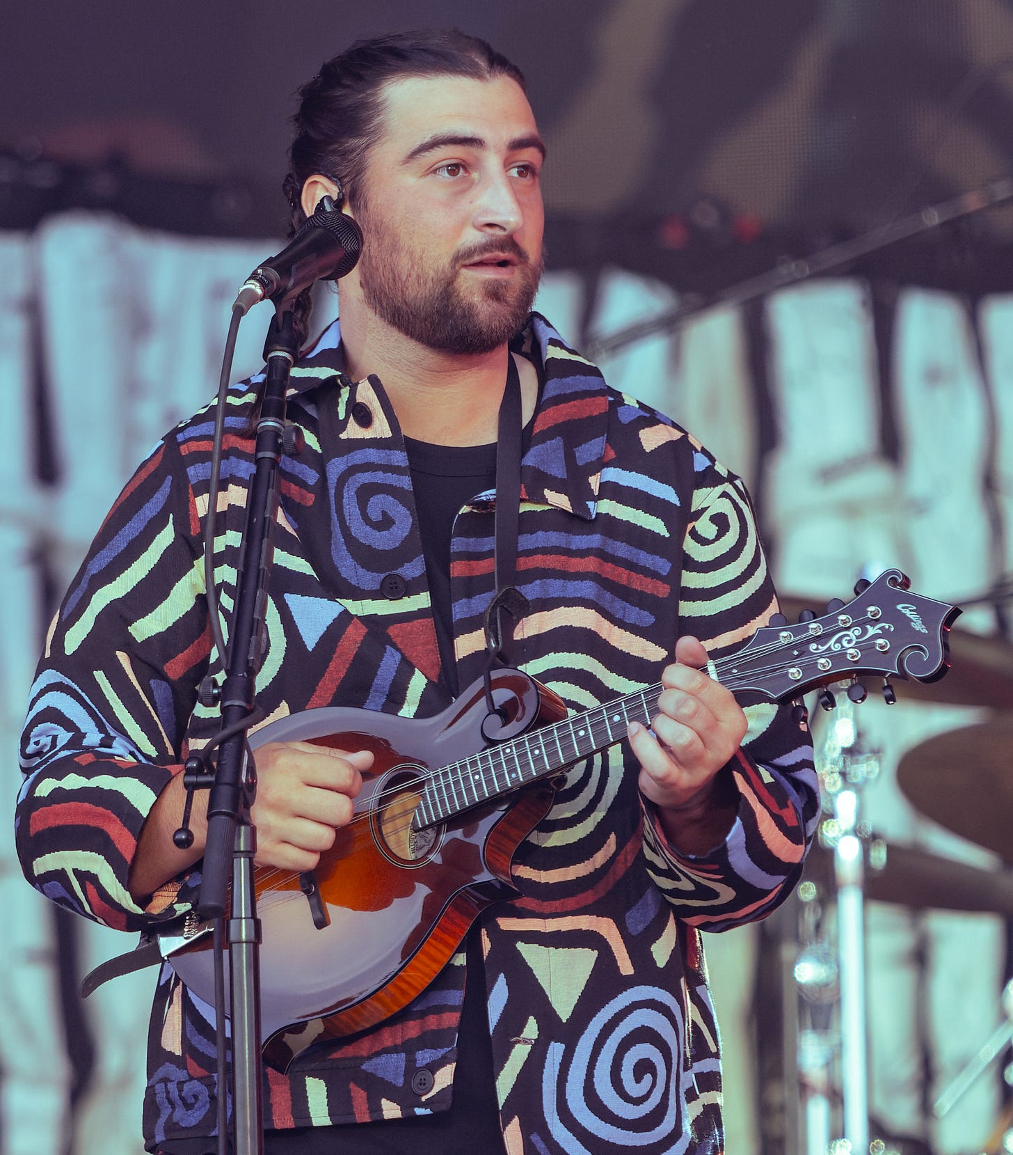 Noah Kahan performs in scottland with very colorful garb.