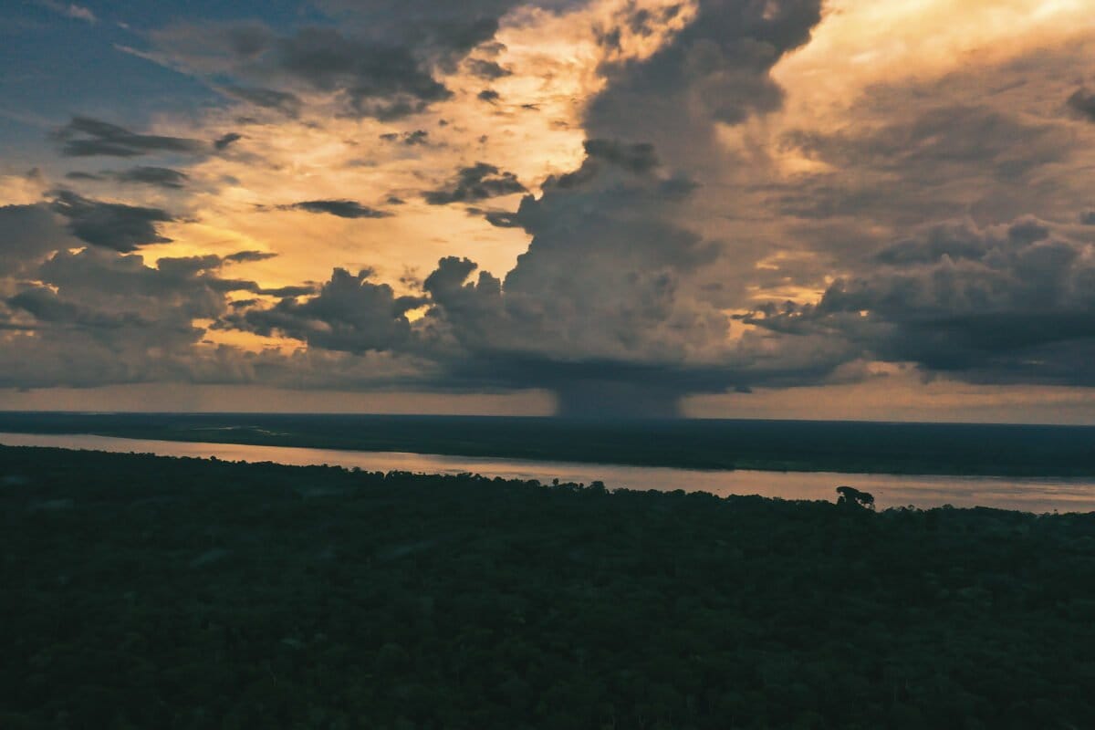 Cloud burst over the Amazon rainforest, with the Amazon River in the foreground. Photo by Rhett Ayers Butler