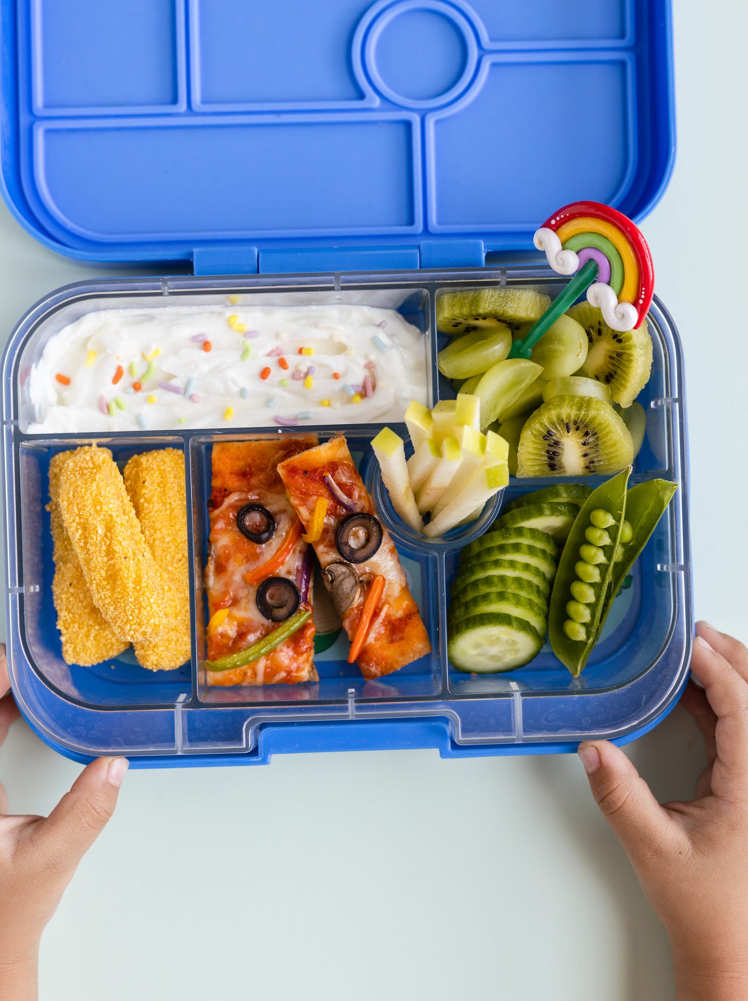 Rainbow Naan Pizza and veggies in a blue Lunchbox Rainbow Naan Pizza and veggies in a blue Lunchbox