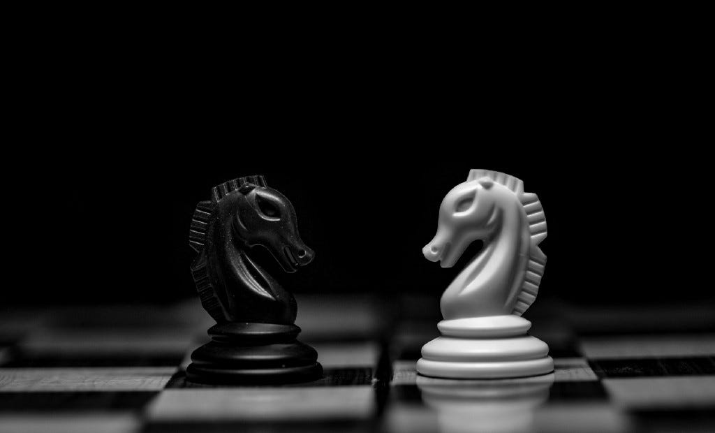 Two chess knights opposing each other (black and white)