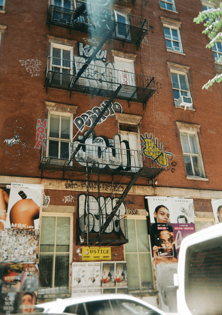 Film photos of my friend at a sushi restaurant, a brick graffitied building in Manhattan, the on-set photographer for my friend's short film, and some fans after Knicks finals game 4