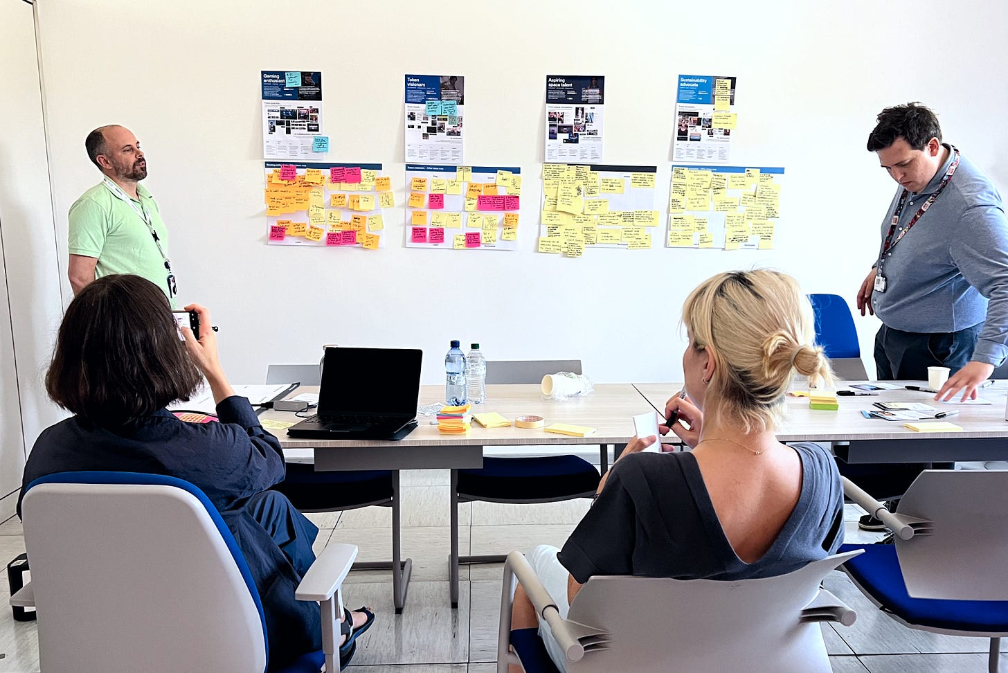 Four people in a room are brainstorming ideas