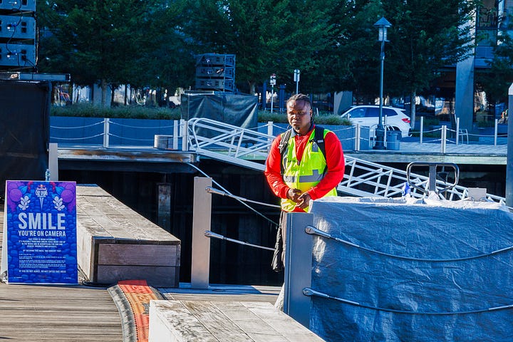 Four Seaport candids: people resting on granite blocks, a dock worker, a woman with her dog, and a woman at a table on the lawn