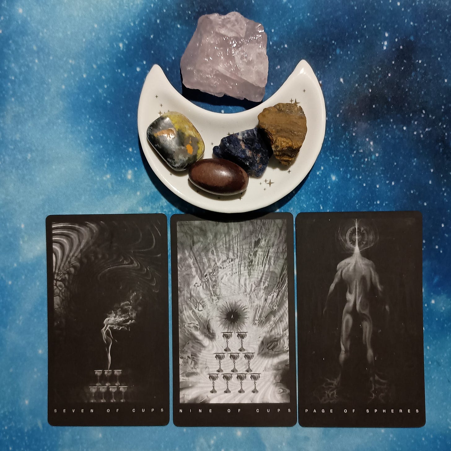 Abundance All Around You ~ A Message From the Universe, Black Tarot cards and crystals on a starry blue background Abundance All Around You ~ A Message From the Universe, Black Tarot cards and crystals on a starry blue background