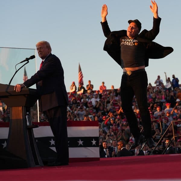 Donald Trump speaking to crowds at a lectern while Elon Musk jumps with arms upraised. 
