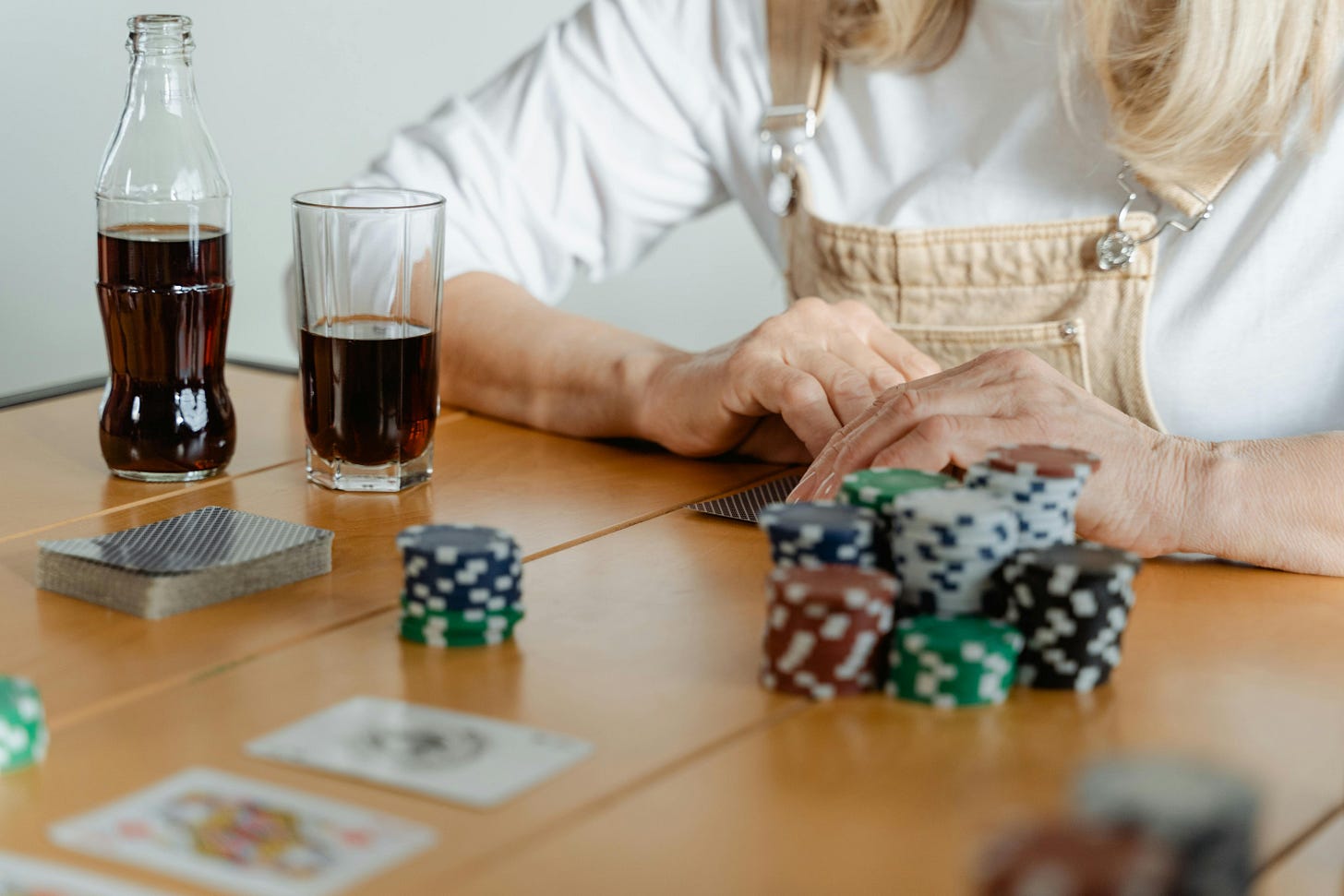 Woman paying poker at a table with poker chips