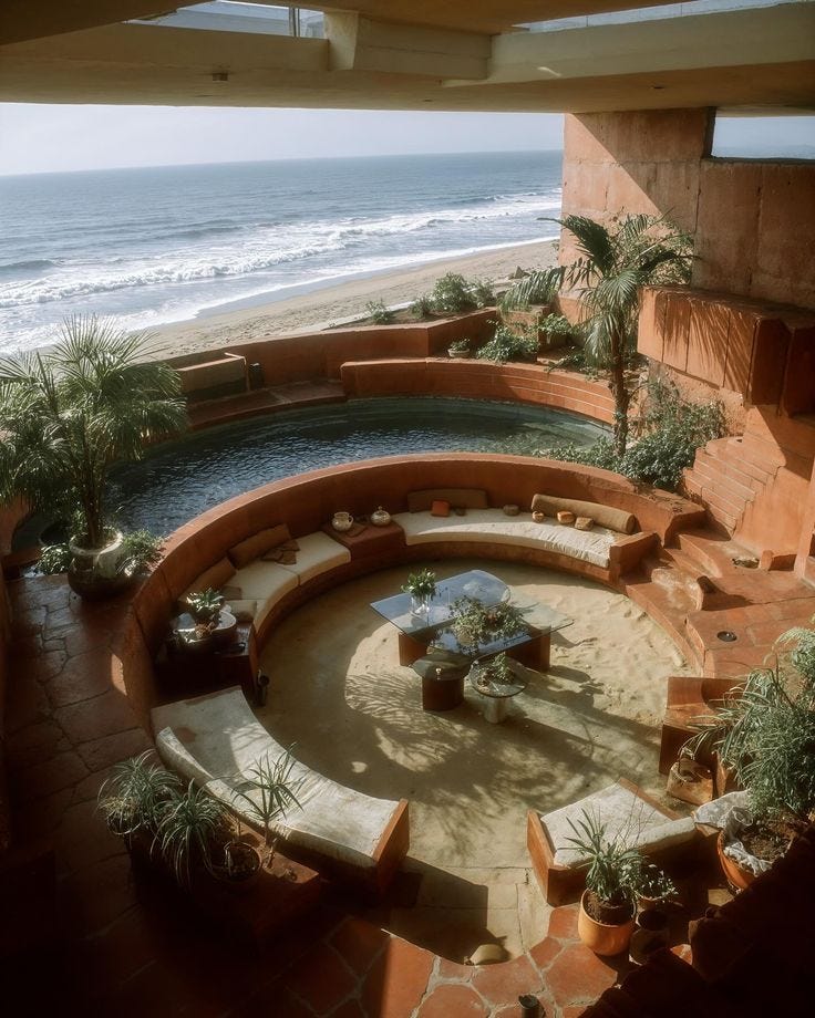 This may contain: an outdoor living area overlooking the beach and ocean