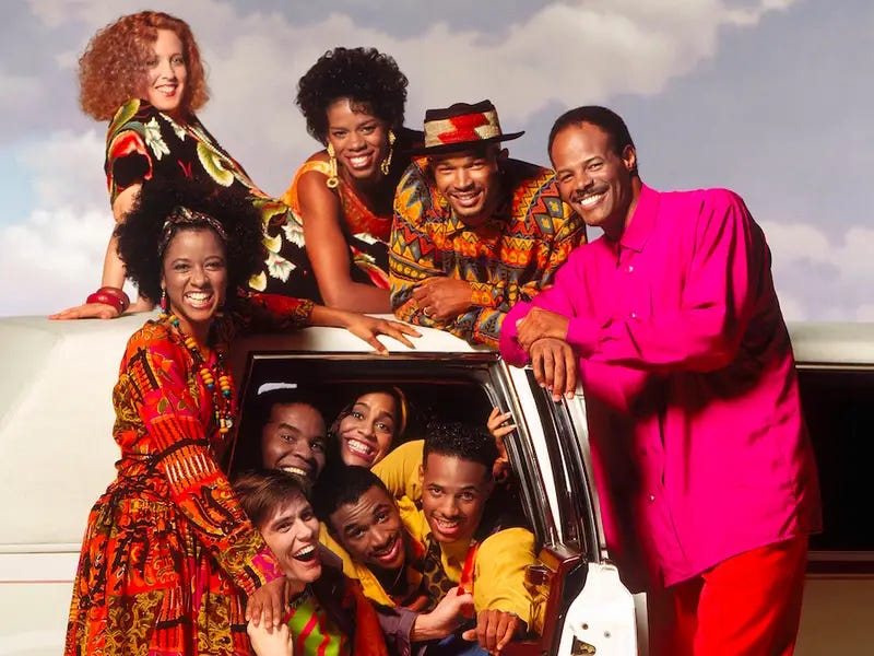 A group of ten people (two white, eight Black) pose for a picture inside of and outside of a white van.