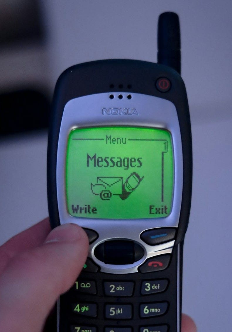 a person holding a cell phone with a message on it