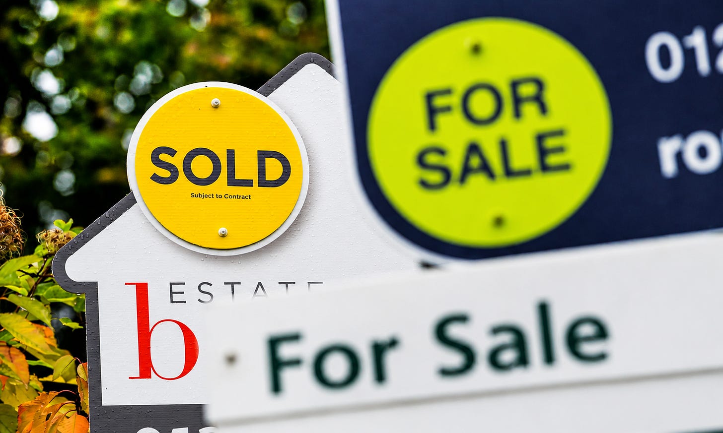 Real Estate “Sold” Sign Outside Residential Property | Stock Photo Real Estate “Sold” Sign Outside Residential Property | Stock Photo