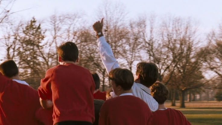 This may contain: a group of people in red shirts are playing frisbee