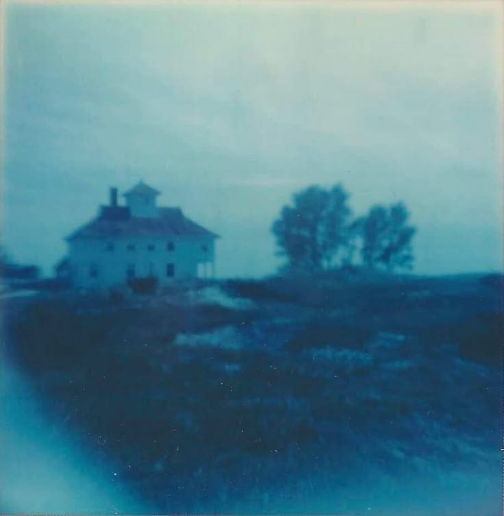 This may contain: an old house sitting on top of a hill