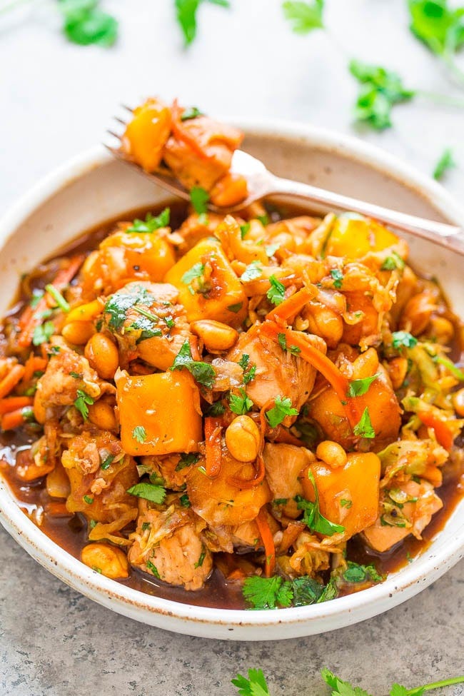 A bowl of hearty vegetable stew garnished with fresh cilantro.