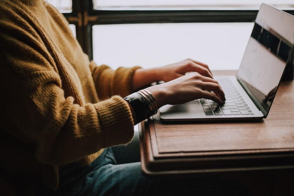 person sitting front of laptop person sitting front of laptop