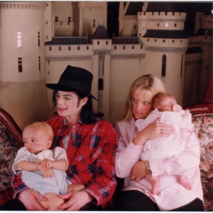 This may contain: two women and a baby sitting on a couch This may contain: two women and a baby sitting on a couch