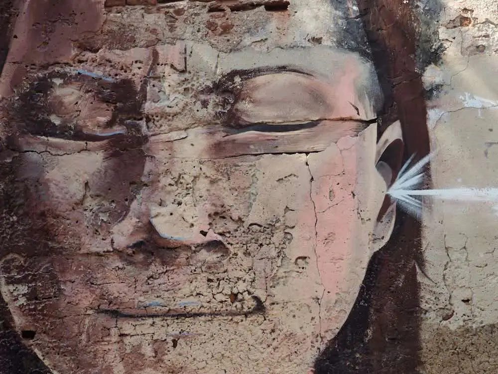 Getsemani street art - face with eyes shut Getsemani street art - face with eyes shut