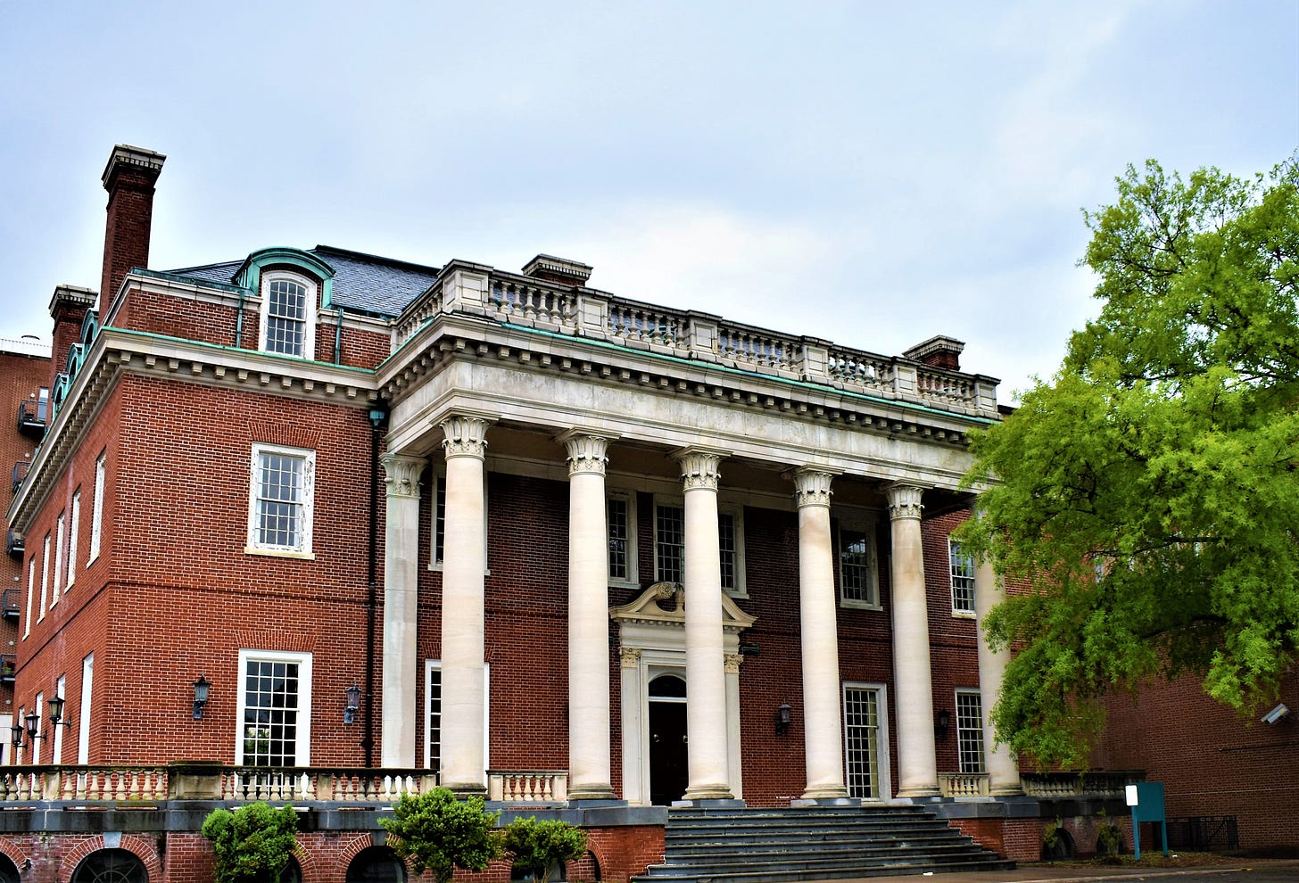 brick house with 8 white pillars.