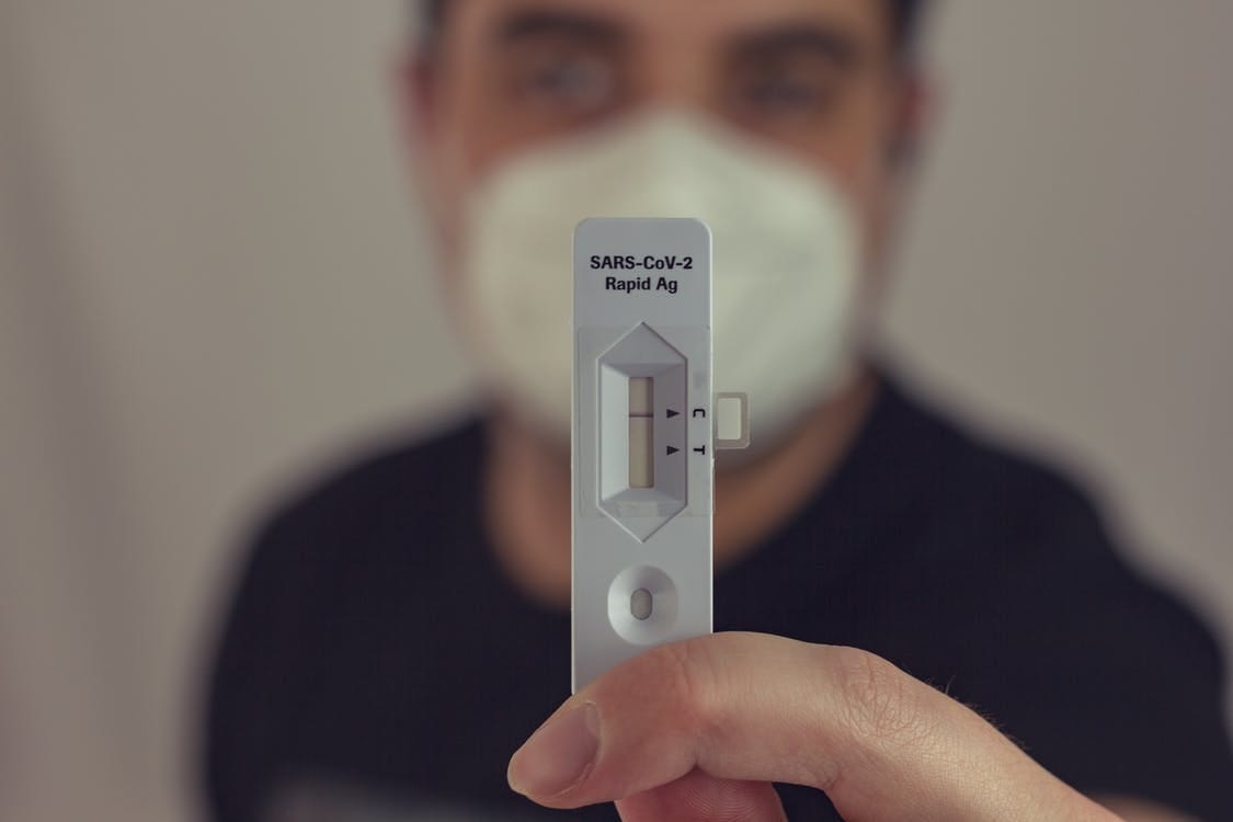 Person Holding White Remote Control